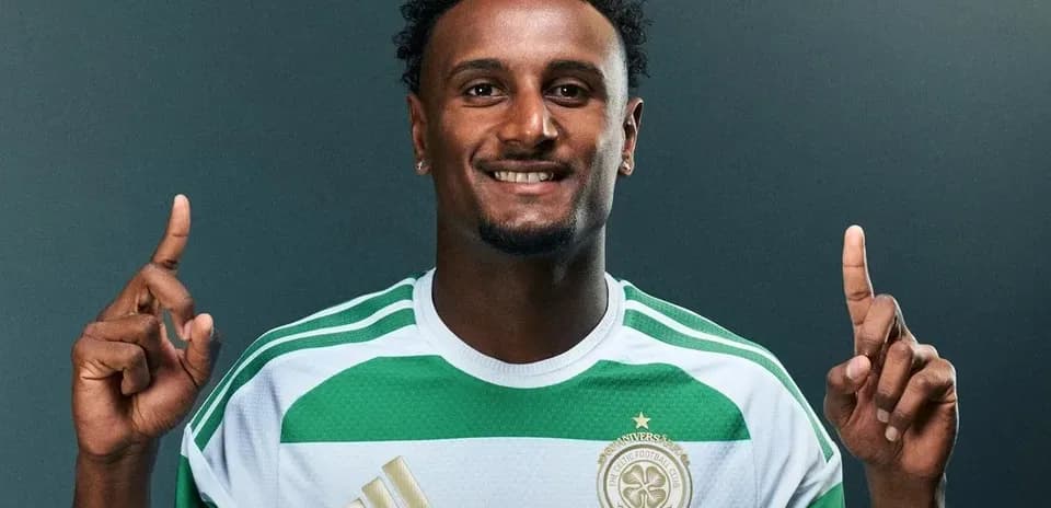 Player posing in Celtic FC jersey with finger raised