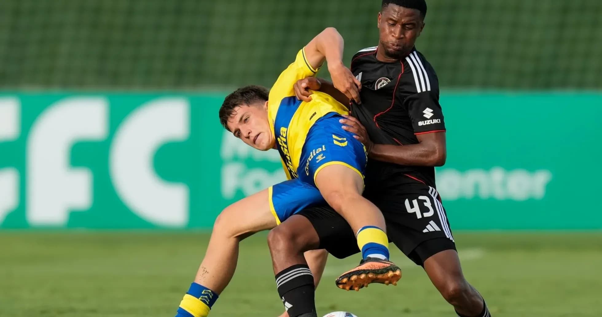 Two players battling for the ball during match