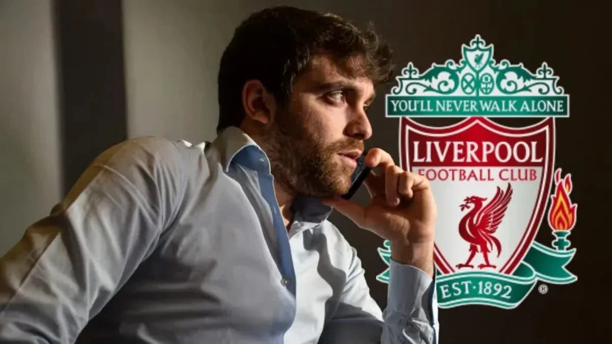 Man on phone with Liverpool FC logo in background