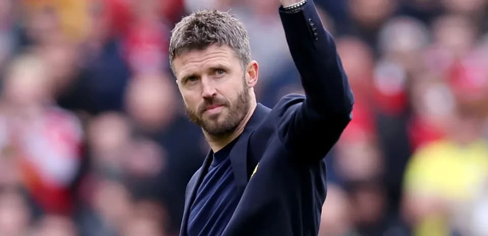 Coach waving to fans during match
