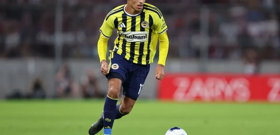 Fenerbahçe player dribbling the ball on pitch