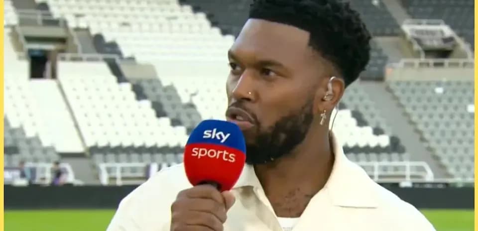 Presenter speaking into microphone at sports venue