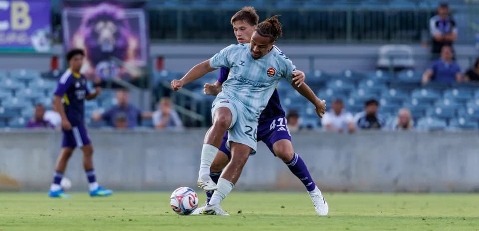 Players battling for the ball during match