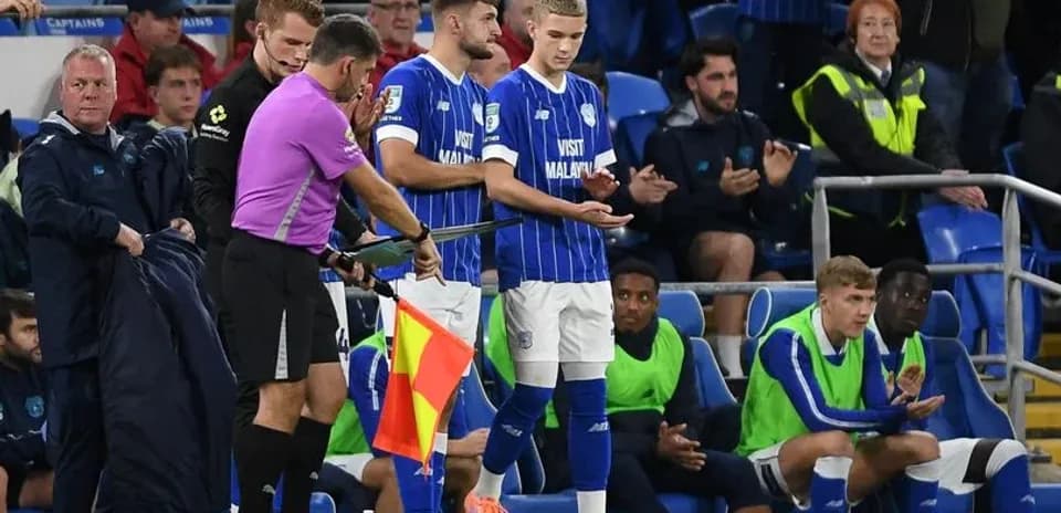 Substitution taking place on football pitch