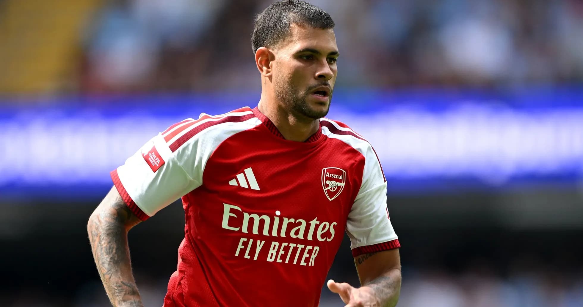 Player in Arsenal kit running on the pitch