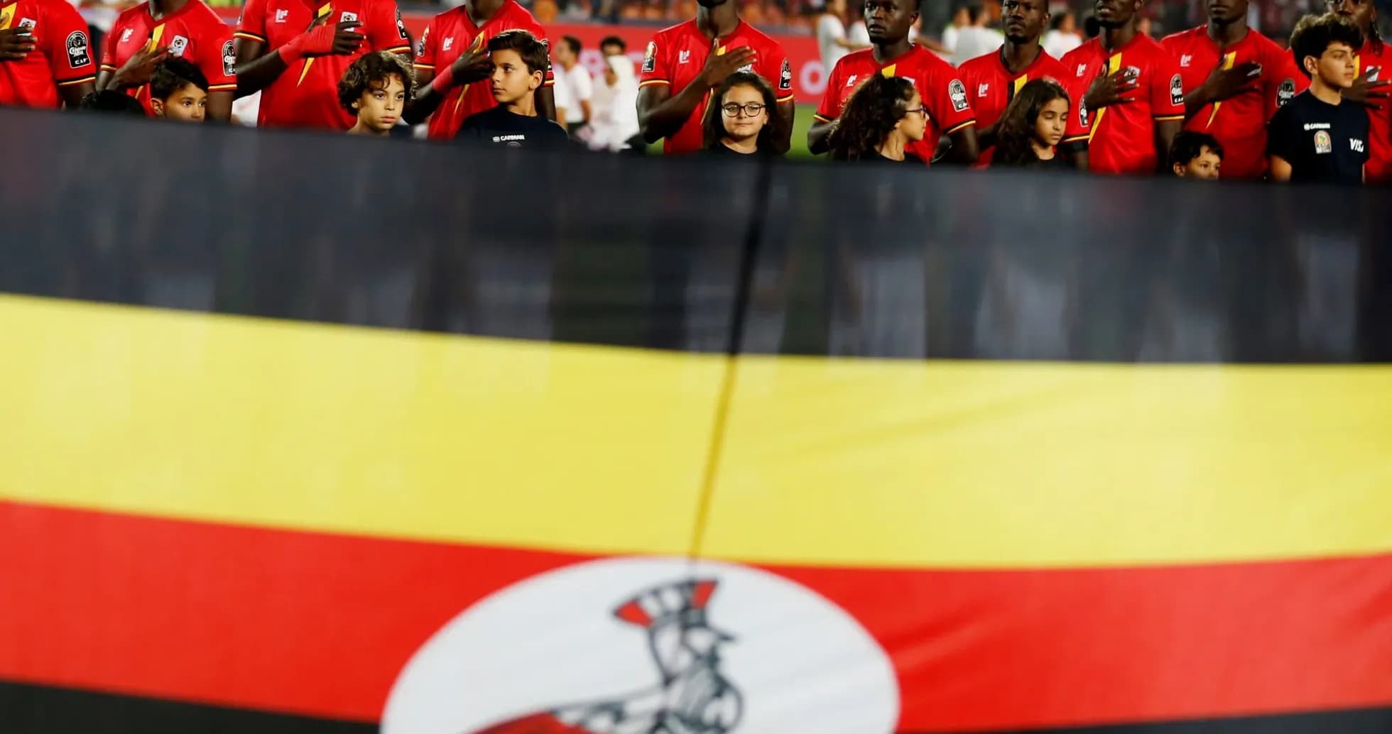 Players and children with Ugandan flag at event