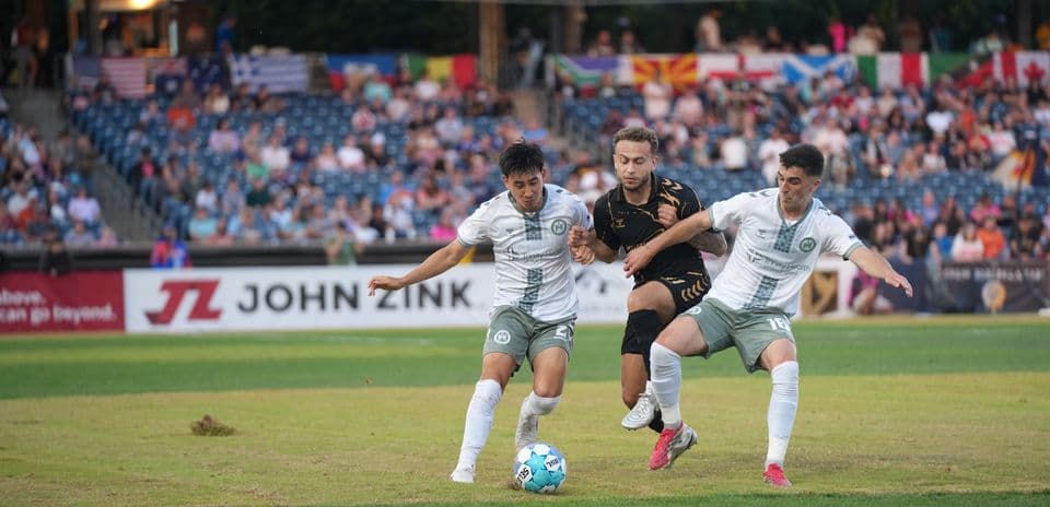 Players contesting for the ball during match