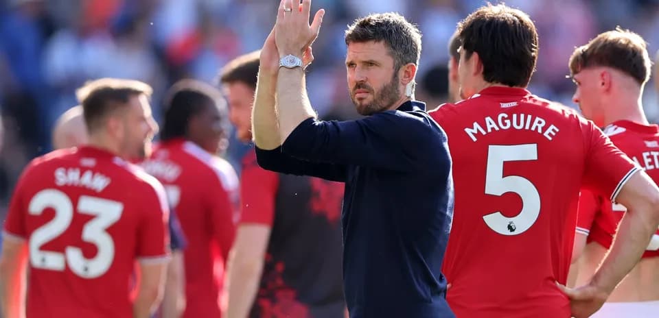 Manager applauding players after match with team
