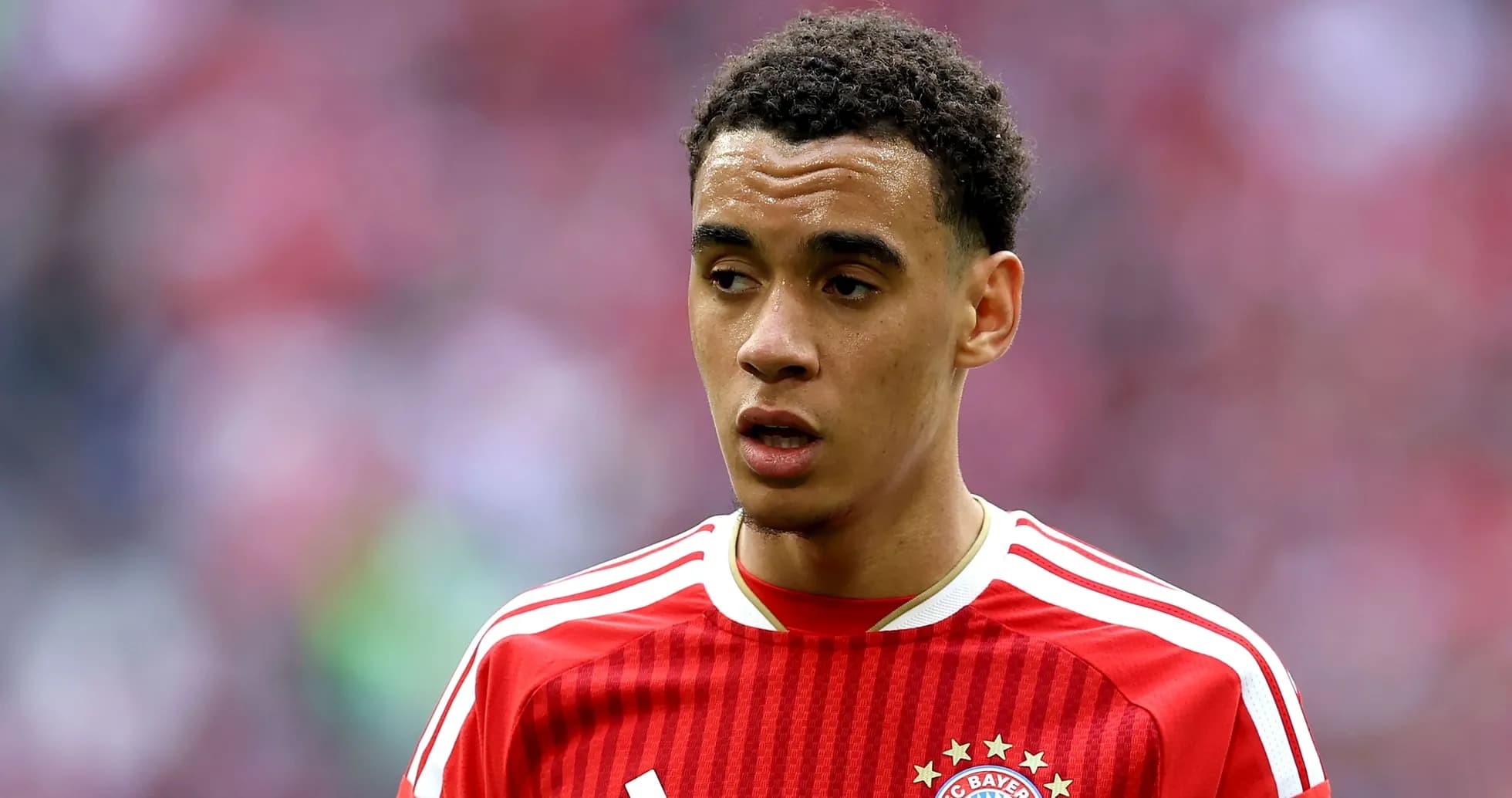 Player in red Bayern Munich jersey on field