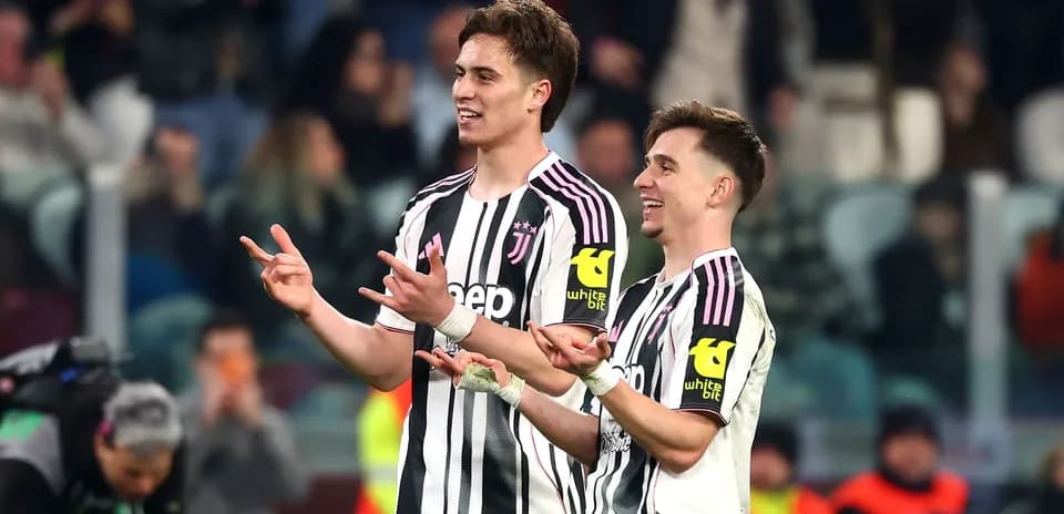 Two Juventus players celebrating on the pitch