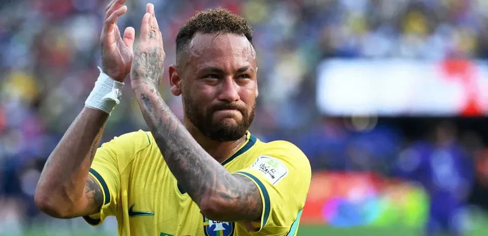 Player applauding fans wearing Brazil jersey