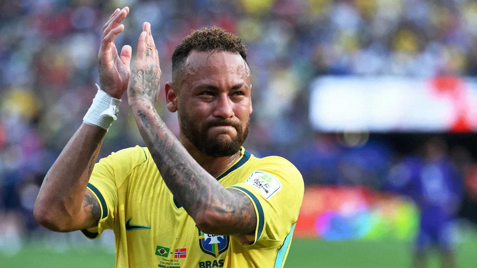 Player applauding fans wearing Brazil jersey