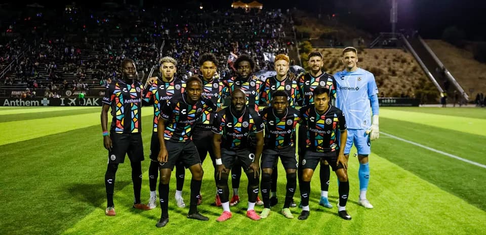 Oakland Roots team posing on the field