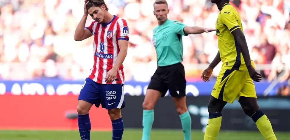 Atletico Madrid player reacts after a foul during match