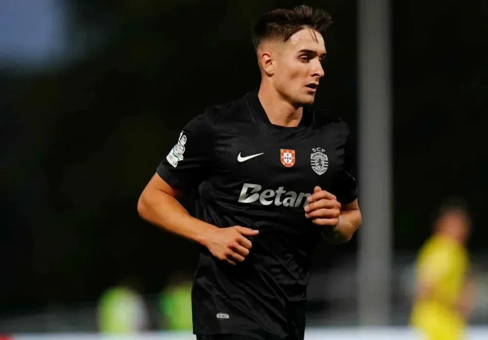 Player running on field in black kit
