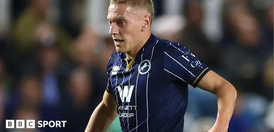 Player in blue kit running during a match