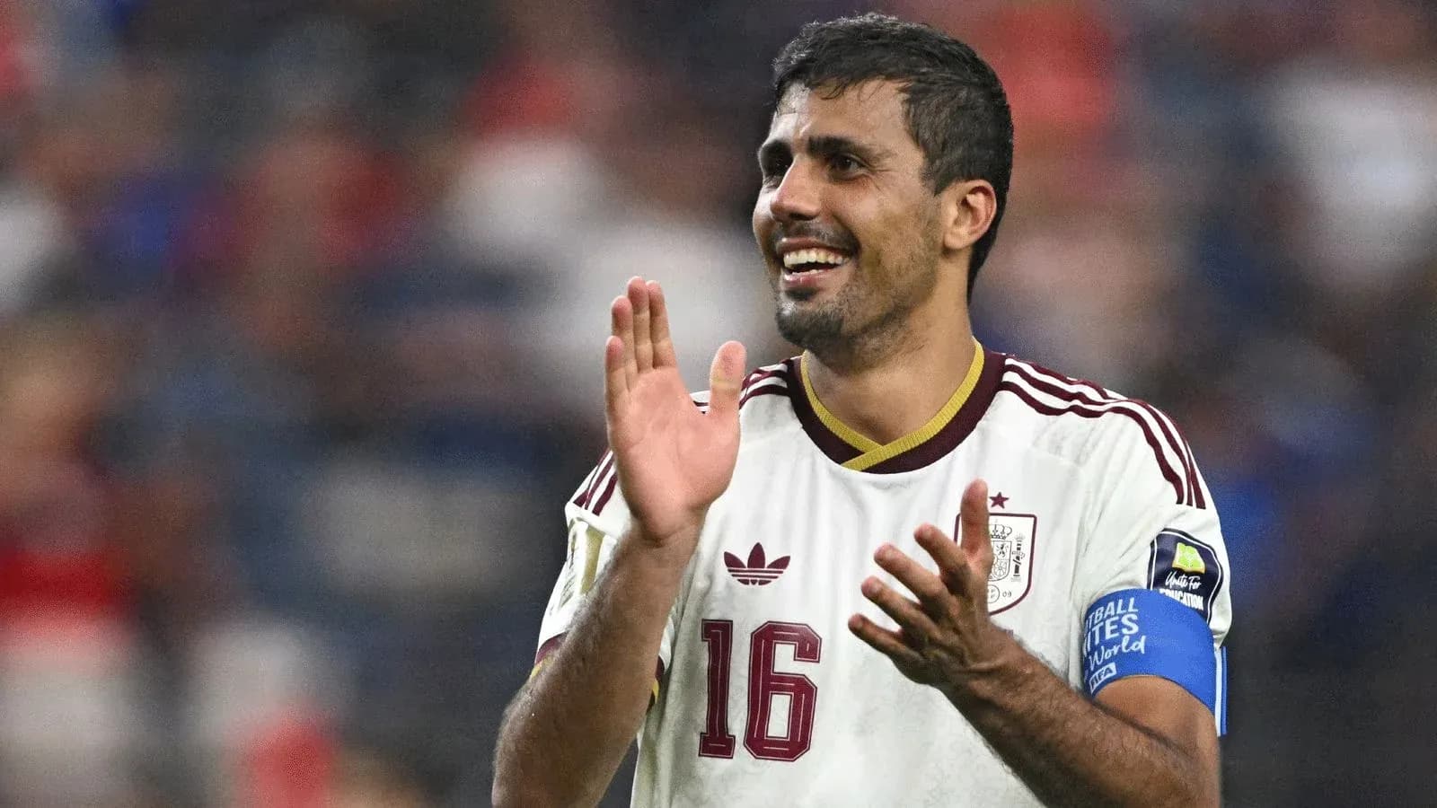 Player applauding fans during a match