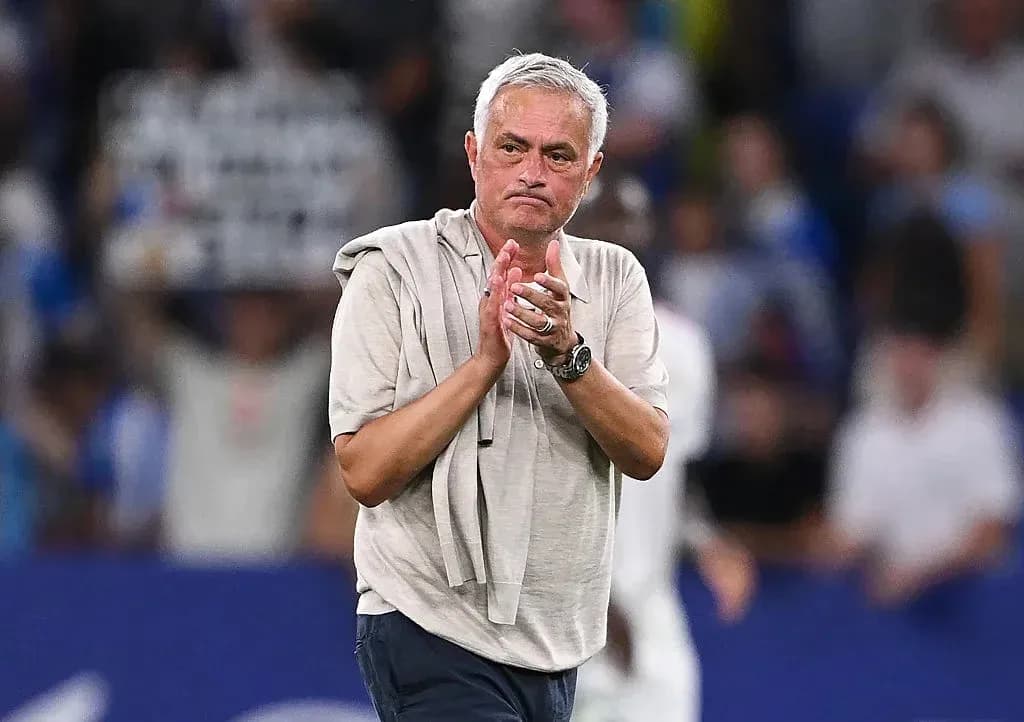Manager clapping on the sideline during match