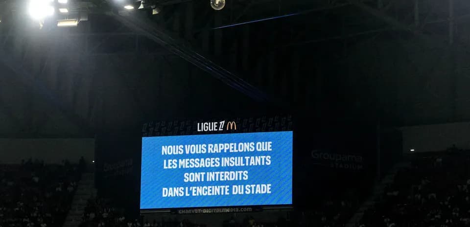 Stadium screen displaying anti-insult message during match