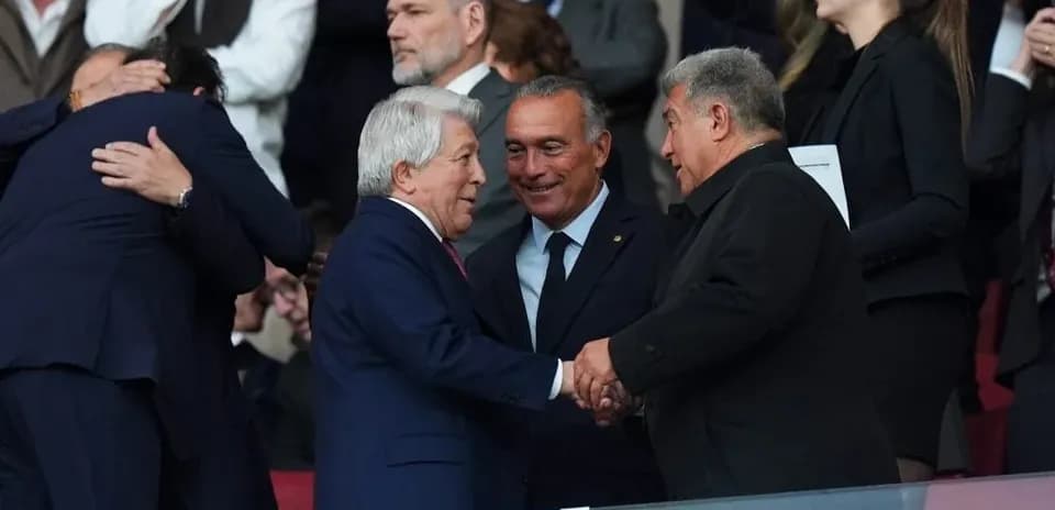 Executives greeting each other in stadium stands