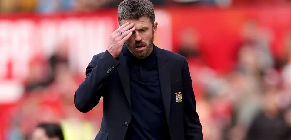 Manager walking on pitch with hand on forehead
