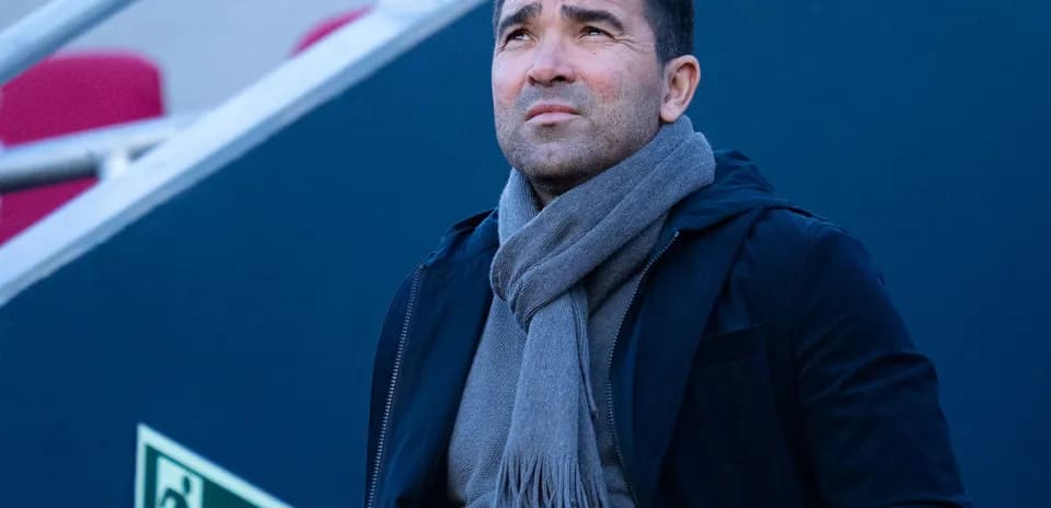 Man looking up while wearing a scarf outdoors
