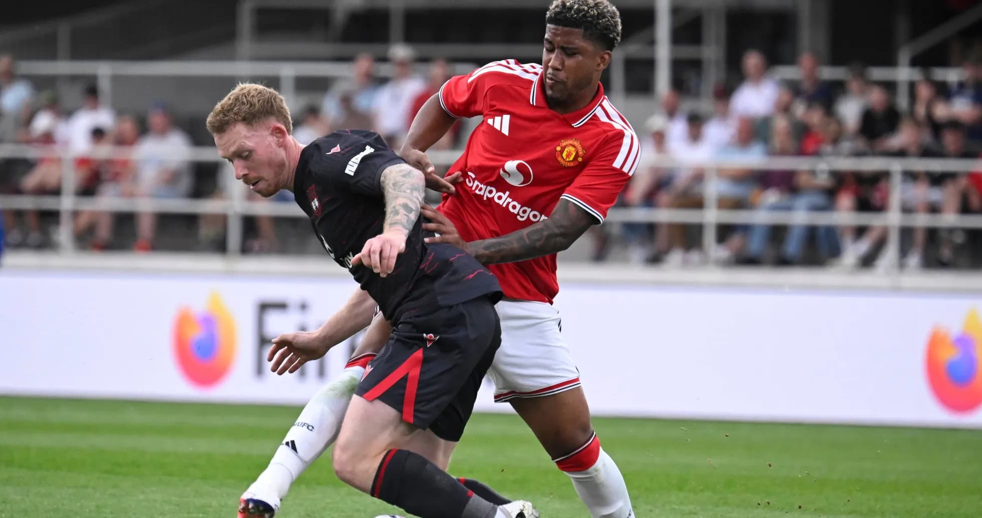 Player tackling opponent during football match action