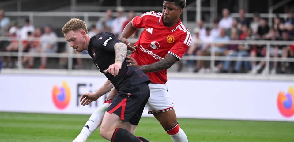 Player tackling opponent during football match action