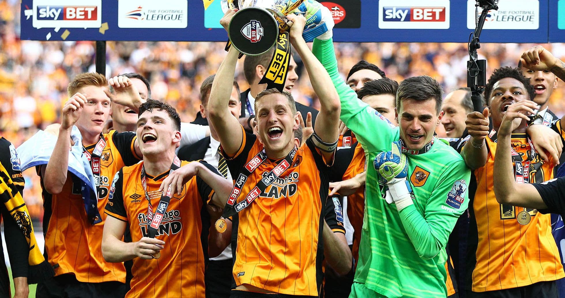 Team celebrating with trophy after championship victory