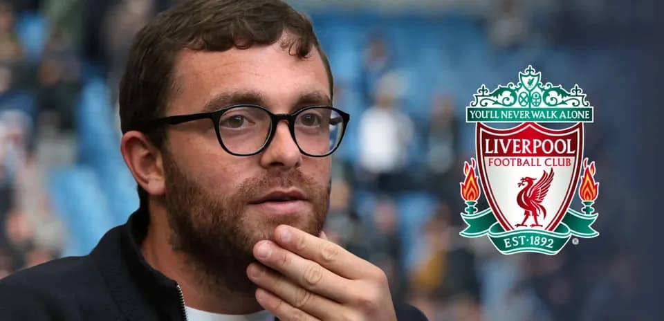 Person with glasses in front of Liverpool FC logo