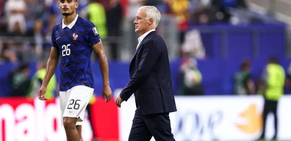 France coach walking past player on the pitch