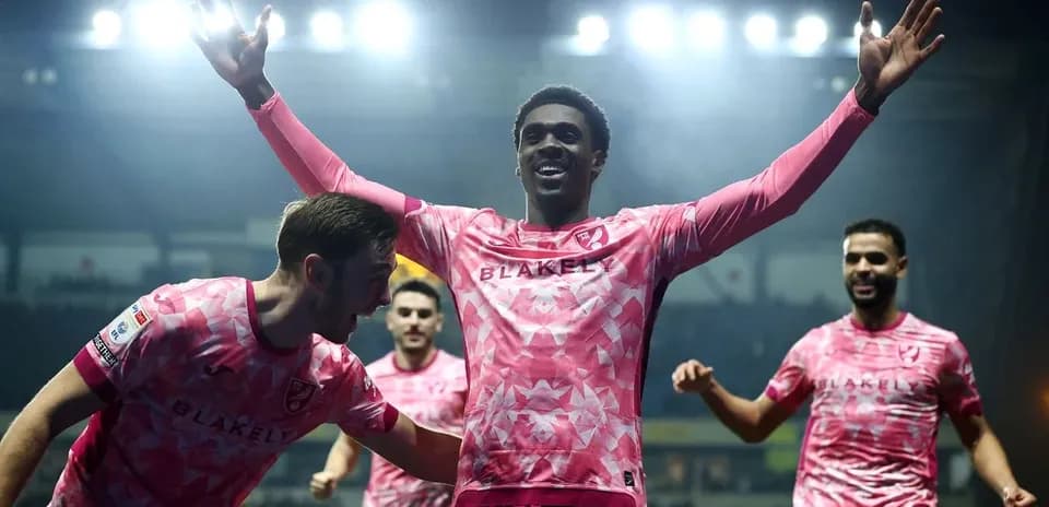 Players celebrating a goal during a match