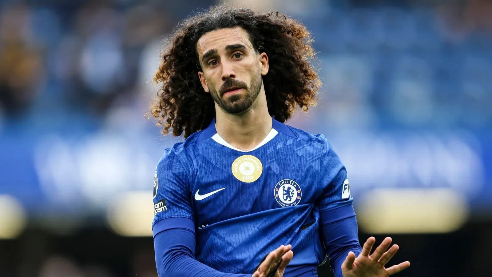 Player in blue Chelsea kit gesturing on the field