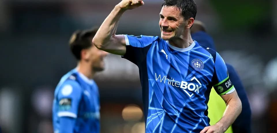 Player celebrating victory in blue team jersey