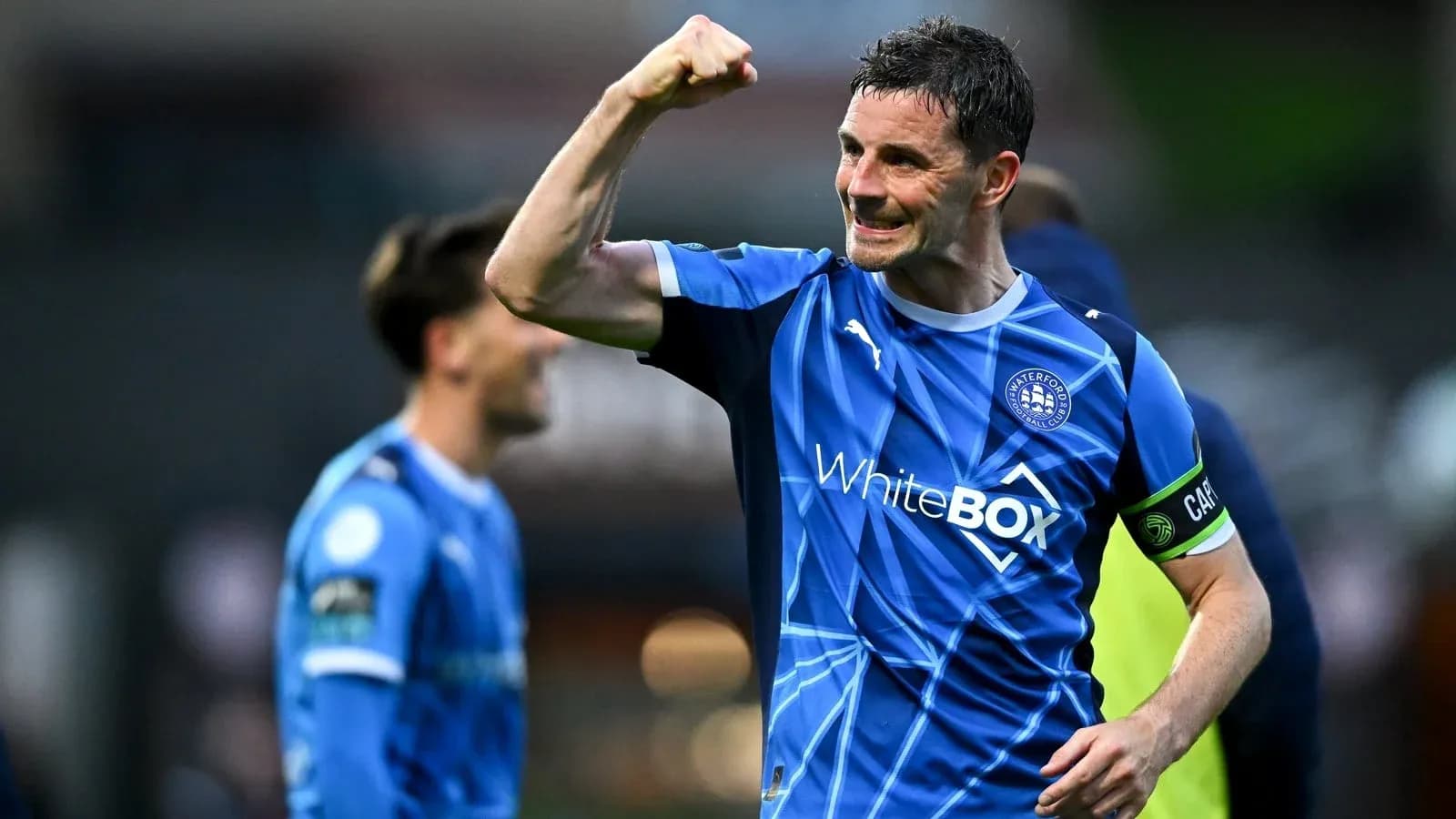 Player celebrating victory in blue team jersey