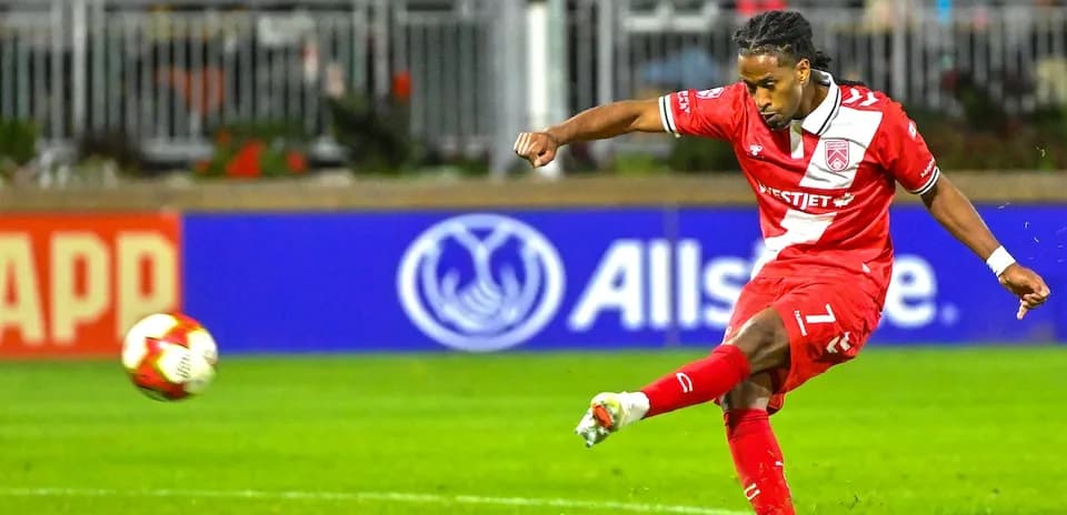 Cavalry FC player taking a shot on goal