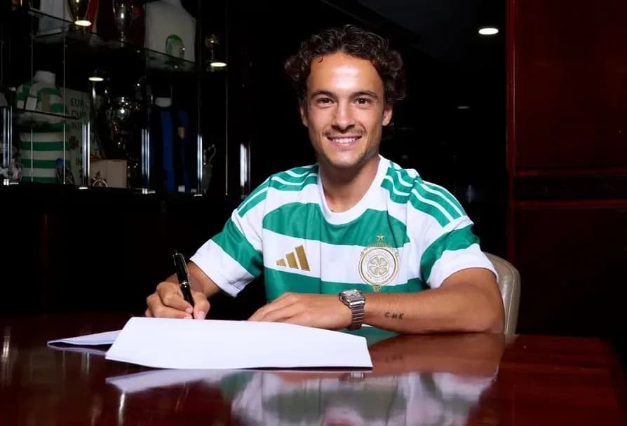Player signing contract while wearing club jersey Player signing contract while wearing club jersey