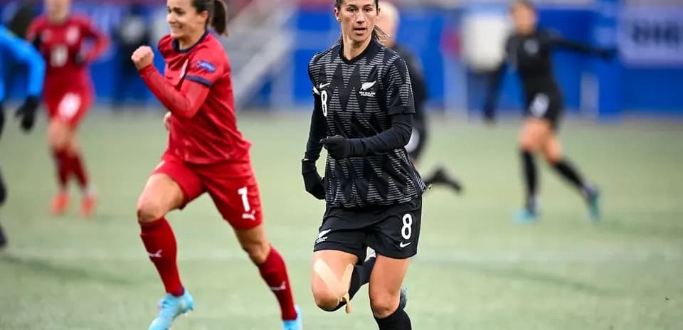 Player in black jersey running during match