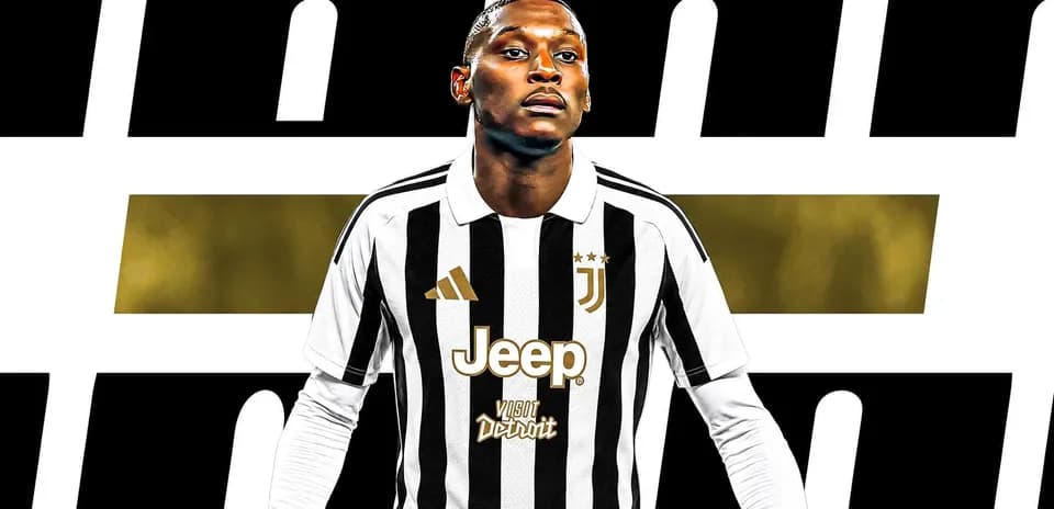 Juventus player in home jersey posing confidently