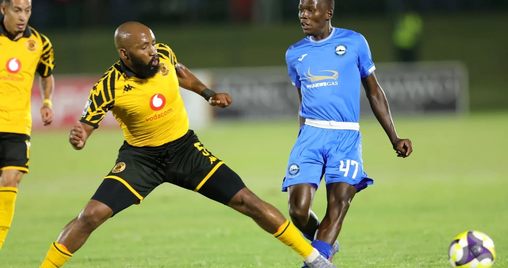 Player dribbling past opponent during a soccer match