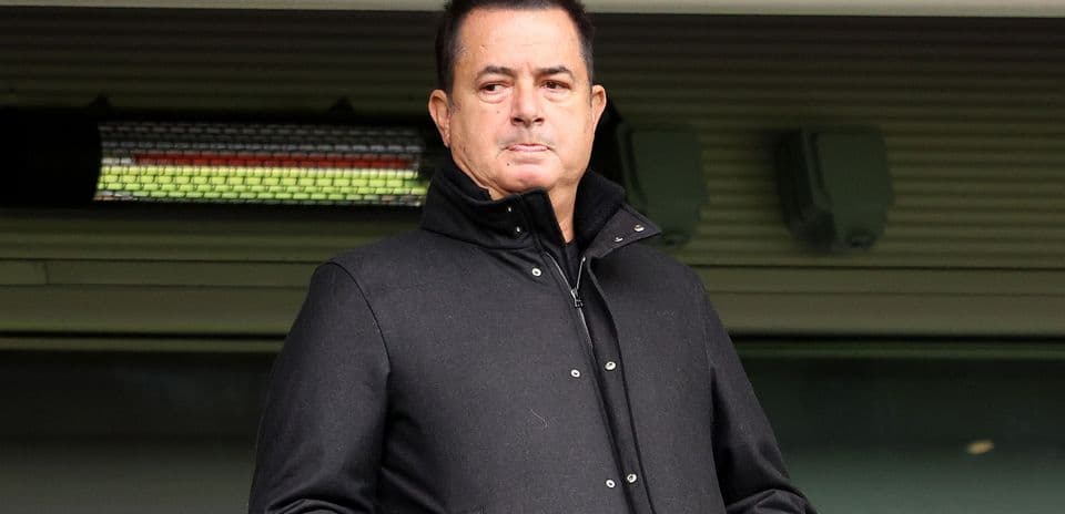 Man in black coat standing at stadium
