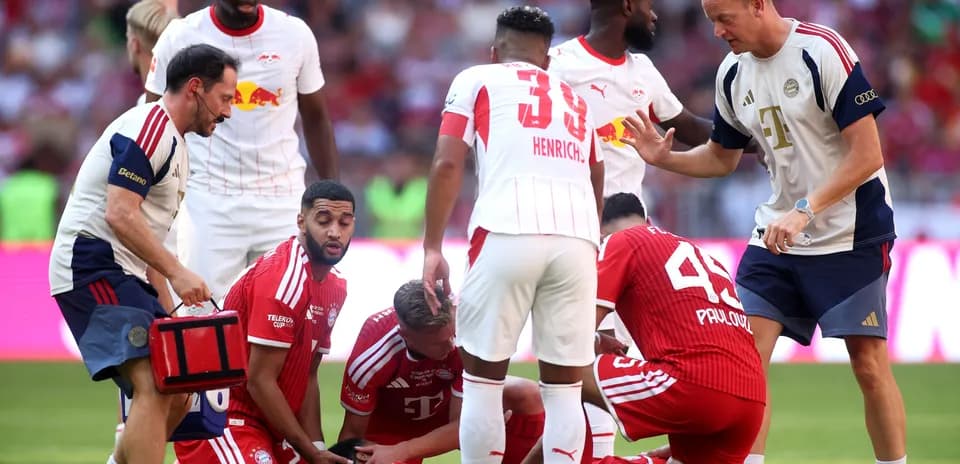 Players and medical staff attending to injured teammate
