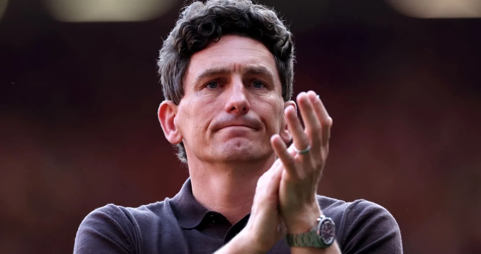 Coach applauding during match at the stadium