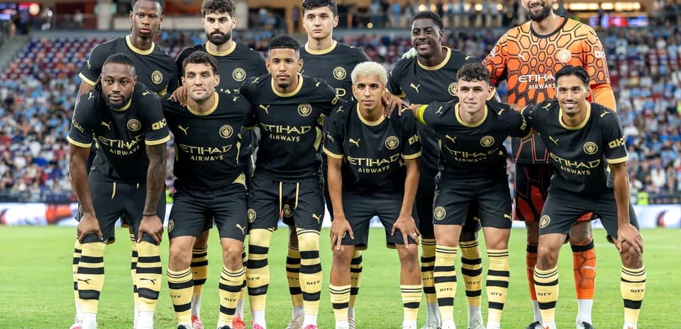 Soccer team posing for group photo in black kits