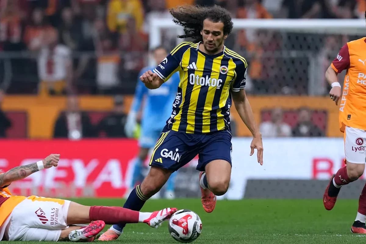 Fenerbahçe player evading a sliding tackle during match