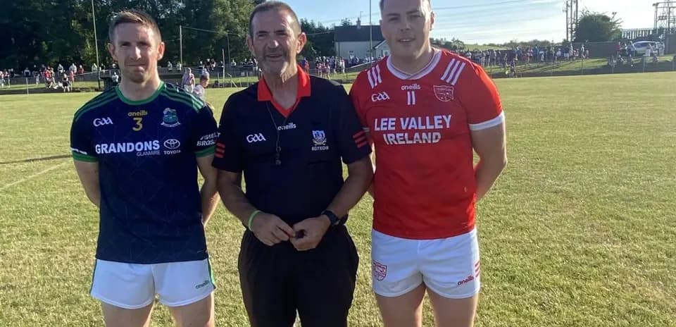 Two players and referee posing before a match