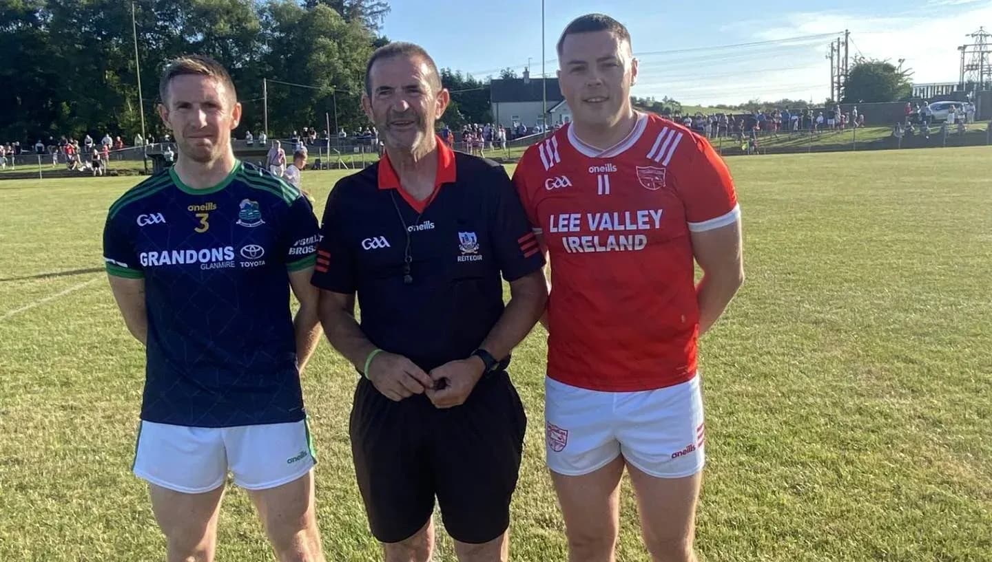 Two players and referee posing before a match