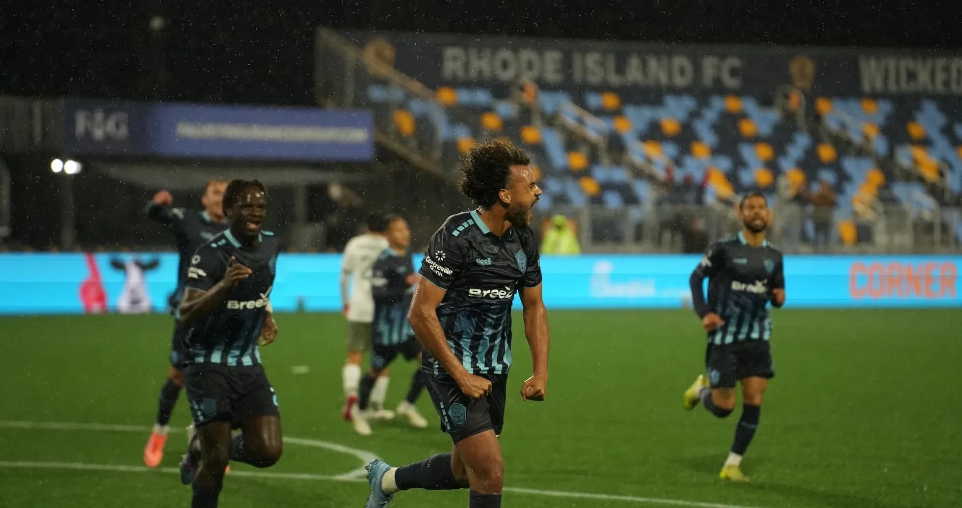 Rhode Island players celebrating a goal during match