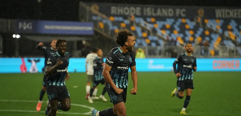Rhode Island players celebrating a goal during match