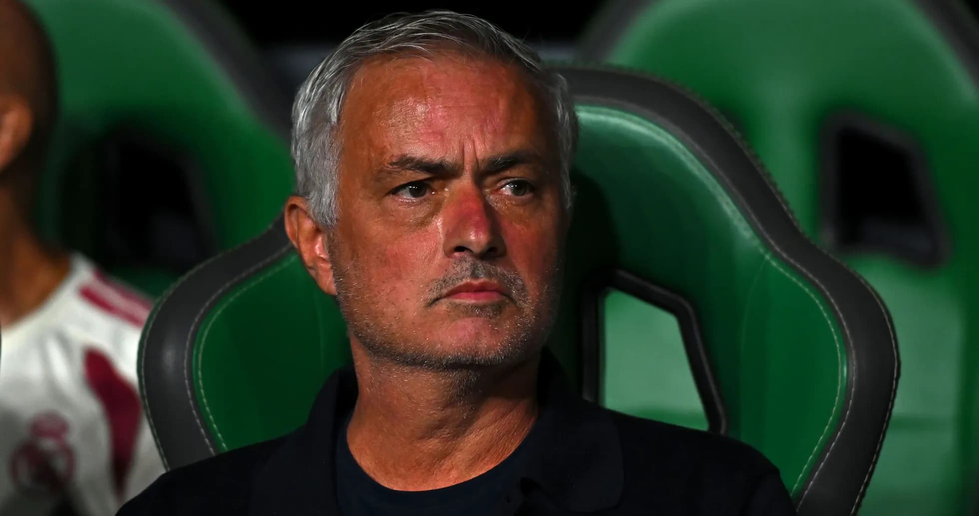 Coach sitting on bench during match